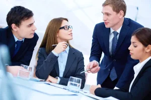 Business professionals consulting on LLC reinstatement and corporation renewal compliance requirements for maintaining good standing