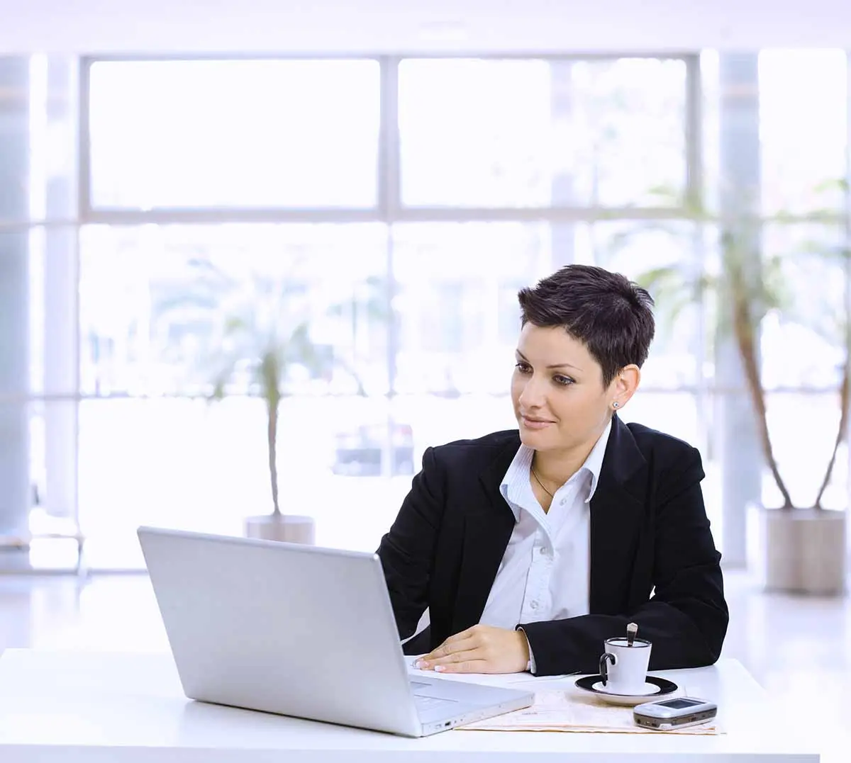 Entrepreneur reviewing business finances on laptop while deciding between sole proprietor vs S corp structure