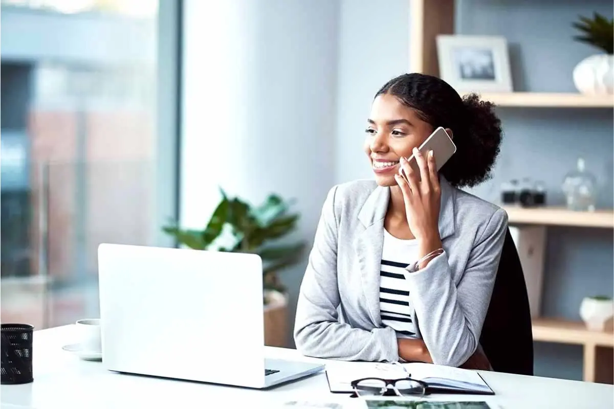 Entrepreneur starting an LLC online while working on a laptop in a modern office.