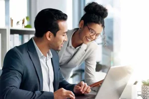 Business owners reviewing LLC formation paperwork and completing the online filing process