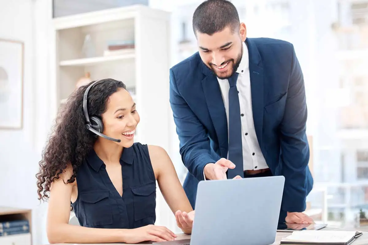 Business professionals discussing single-member LLC vs multi-member LLC options on a laptop